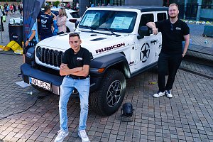 Zwei Mitarbeiter der Autohaus Peter Gruppe präsentieren einen weißen Jeep Wrangler Rubicon beim Erfurter Nachtlauf 2026